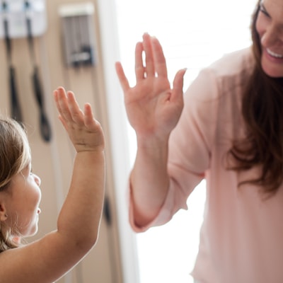 pediatric medicine - Image of doctor high-fiving a young patient